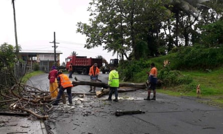 People remove debris due to Cyclone Yasa at Velau Drive in Fiji, December 18, 2020, in this image obtained via social media. Fiji Roads Authority via REUTERS ATTENTION EDITORS - THIS IMAGE HAS BEEN SUPPLIED BY A THIRD PARTY. MANDATORY CREDIT. NO RESALES. NO ARCHIVES.