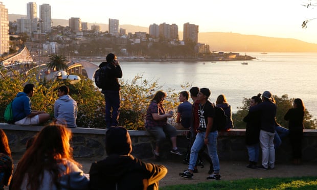People look out towards the ocean on Cerro Castillo hill, after a mass evacuation of the entire coastline during a tsunami alert after a magnitude 7.1 earthquake hit off the coast in Vina del Mar, Chile. Photograph: Rodrigo Garrido/Reuters