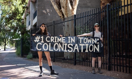 Two protesters outside the Central Australian Aboriginal Congress on Tuesday.