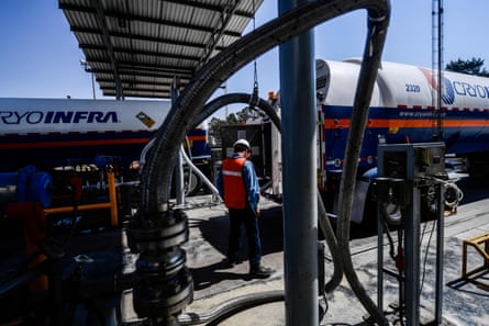 A worker fills a tanker with medicinal oxygen at the Infra Group factory in San Miguel Xoxtla, Puebla, Mexico, March 2021