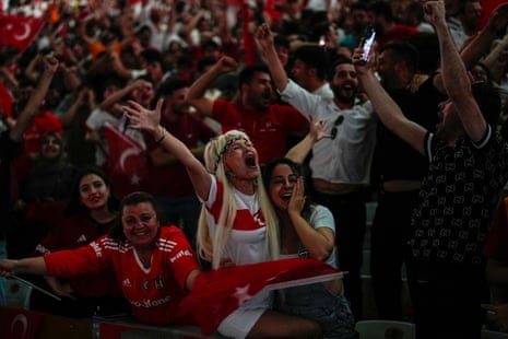 Turkish supporters celebrate the opening goal as they watch the quarter-final match against Netherlands in Berlin, at a screening at Besiktas stadium in Istanbul.