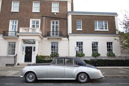 An expensive looking property with a classic Rolls-Royce car parked outside