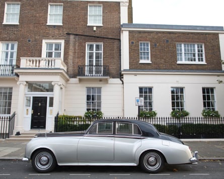 A vintage Rolls-Royce Silver Cloud is parked outside a Belgravia townhouse