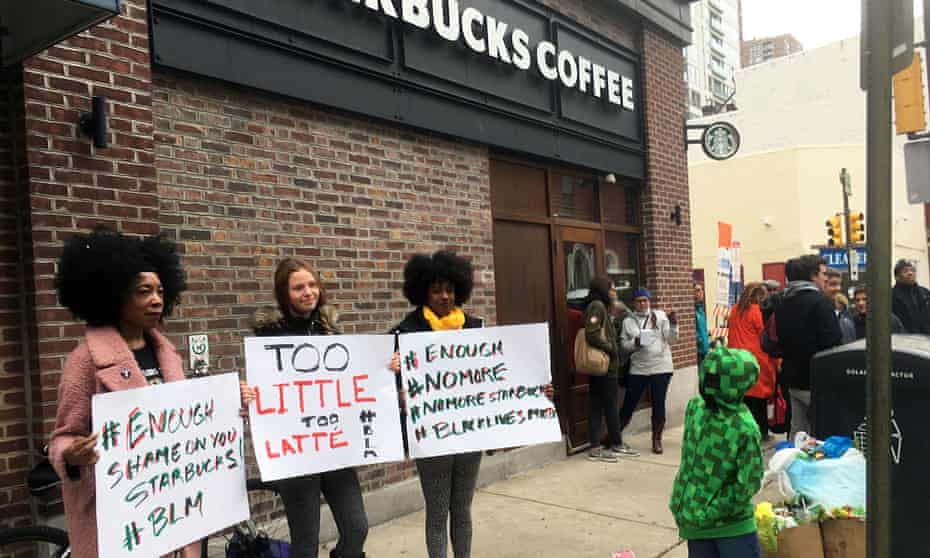 Demonstrators protest outside the Starbucks cafe in Philadelphia where two black men were arrested. 