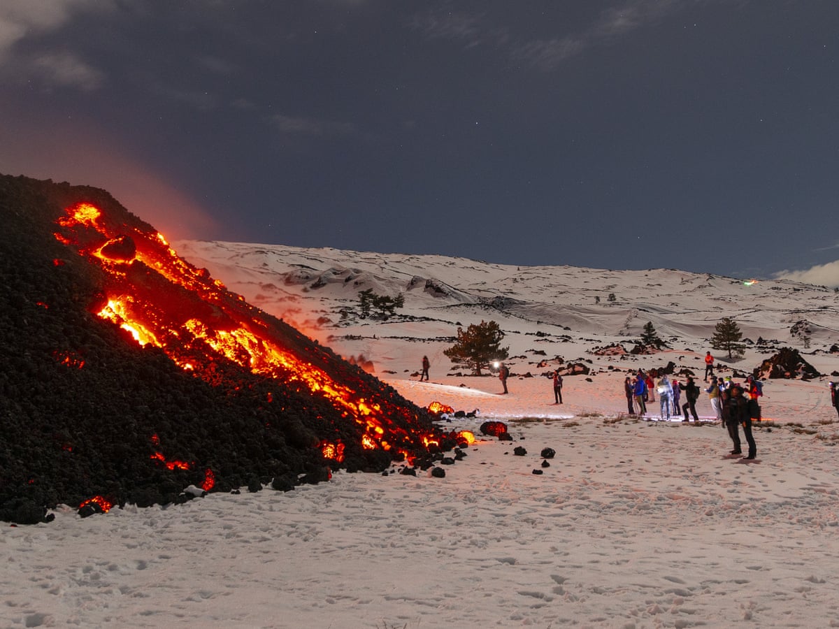 Thousands of tourists flock to see Etna eruption, blocking rescue services | Italy | The Guardian