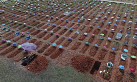 A worker digs a grave in the San Juan Bautista cemetery in Iquitos, Peru