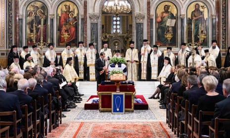 Mourners gathered around coffin
