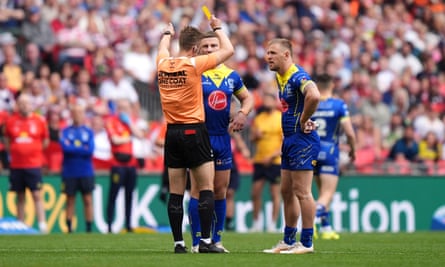 Warrington’s Matt Dufty (right) is shown a yellow card.