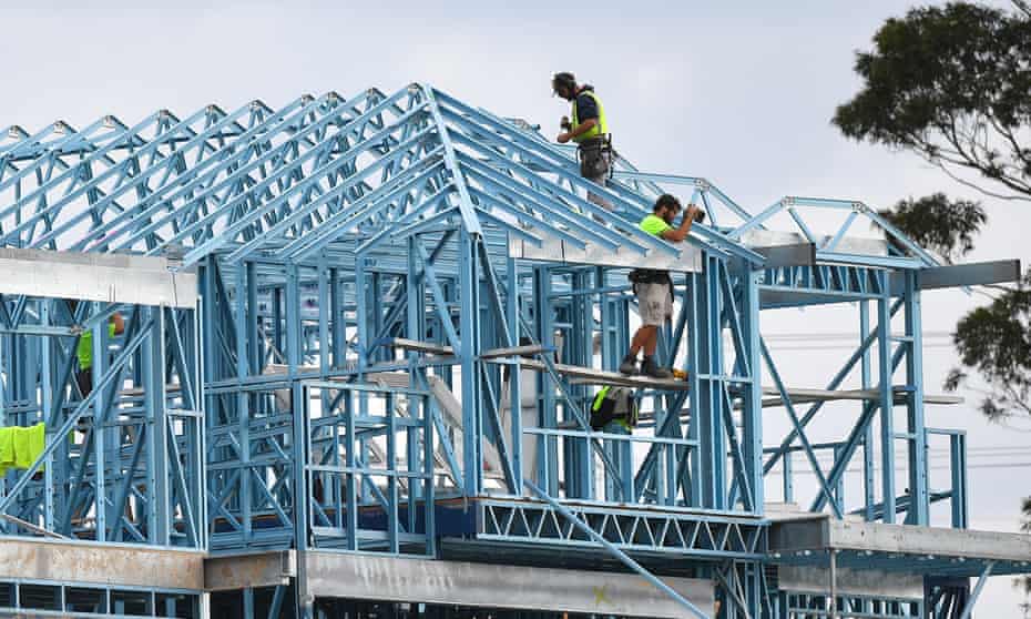 Construction workers are seen working on a new housing development at Kellyville, west of Sydney