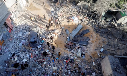 Palestinians inspect the site of an Israeli strike on a house in Rafah, 8 May.