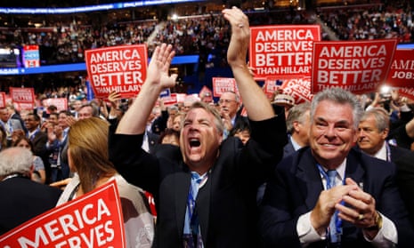 The US representative Peter King of New York and other delegates react as they watch Wisconsin Governor Scott Walker speak during the 2016 Republican National Convention.