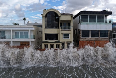 waves crash into a seawall