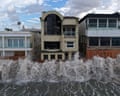 waves crash into a seawall