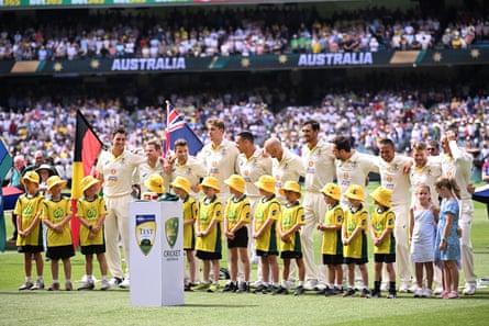 The Australian Test team pay tribute to Shane Warne before play on day one at the MCG.
