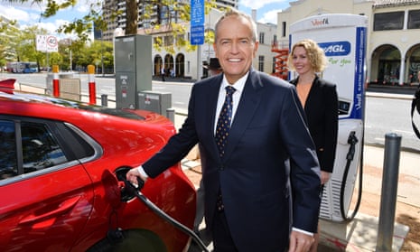 Bill Shorten charges an electric car after launching Labor’s climate change policy in Canberra on Monday