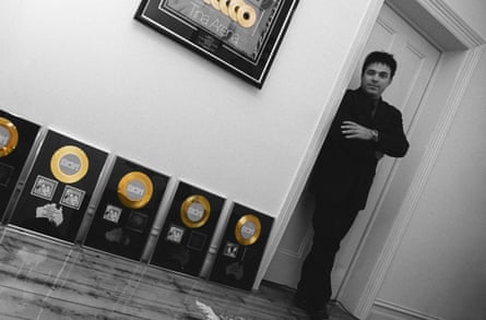 Ralph Carr beside framed gold records