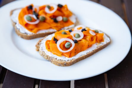 Lox végétalien aux carottes - Saumon fumé végétalien à base de carottes qui est servi sur un pain au levain sain garni d'oignons, de câpres et de caviar d'algues végétalien