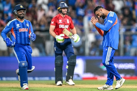 Varun Chakravarthy celebrates with Sanju Samson after taking the wicket of Jos Buttler.