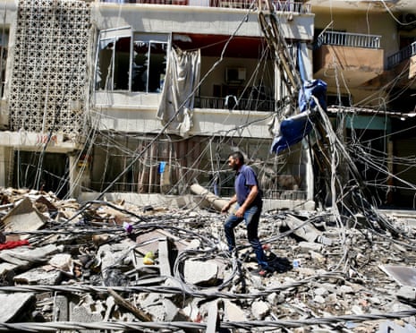 A man walks through rubble after an Israeli strike in Tyre, Lebanon, 12 June 2026.