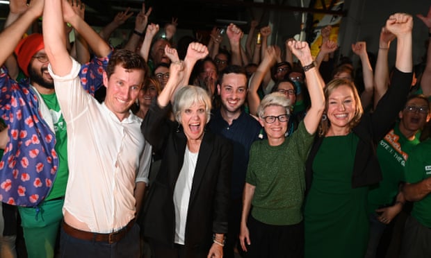 Likely new Queensland Greens MPs Max Chandler-Mather, Elizabeth Watson-Brown and Stephen Bates celebrate with senator Larissa Waters and Senate candidate Penny Allman-Payne.