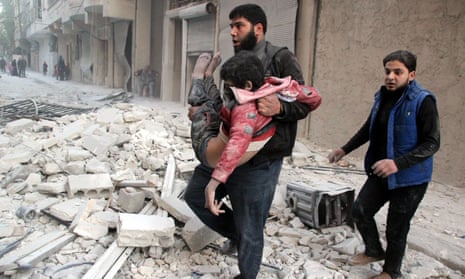 A man pulls a child from the wreckage after a Russian airstrike in Aleppo, Syria.