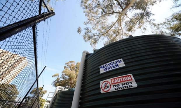 Rainwater tanks are used to harvest water from nearby council housing towers to irrigate a sports field in Fitzroy, Melbourne.