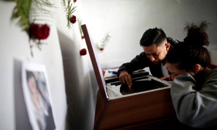 Relatives of Kimberly Fonseca who was shot during a protest mourn next to her coffin.