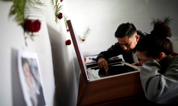 Relatives of Kimberly Fonseca who was shot during a protest mourn next to her coffin in Tegucigalpa.