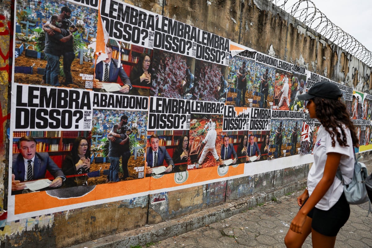 A woman looks at banners depicting former president Jair Bolsonaro, with the words: “Remember that?”