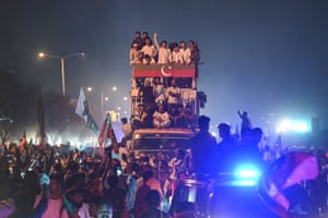 Islamabad, Pakistan. The ousted prime minister Imran Khan waves to supporters from the top of a bus as he leads a rally
