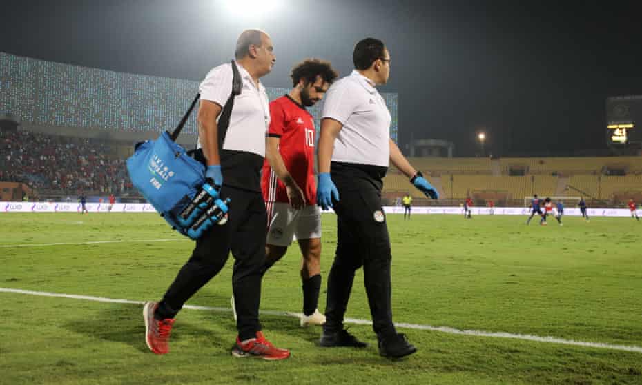Mohamed Salah looks downcast as he leaves the field with Egypt’s doctors