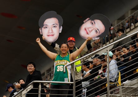 Fans hold up a cut out of Zhou Guanyu in the stands during the sprint qualifying on Friday.