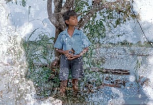 MengHy, 12, collects snails to sell on Tonle Sap lake in Kompong Thom province, Cambodia.