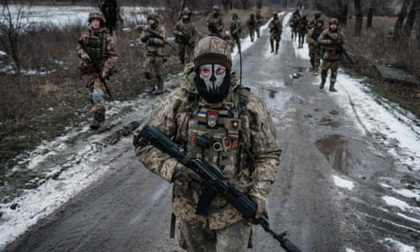 Ukrainian soldiers walk on the road near the frontline in the eastern Donetsk region.