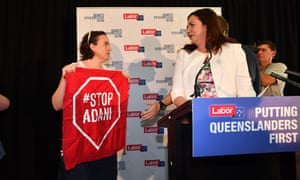 Anti-Adani coal mine protestors invade the stage as Queensland Premier Annastacia Palaszczuk (right) announces the date of the Queensland election 