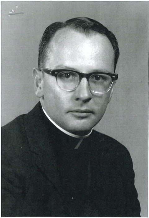 A black and white photo of a priest