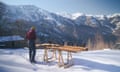 Doolaard with some wooden planks on sawhorses in the snow with mountains in the background