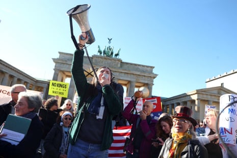 A demonstrator uses a megaphone during a "No Kings" rally against U.S. President Donald Trump and his administration, near the U.S. embassy in Berlin, Germany, October 18, 2025. REUTERS/Christian Mang