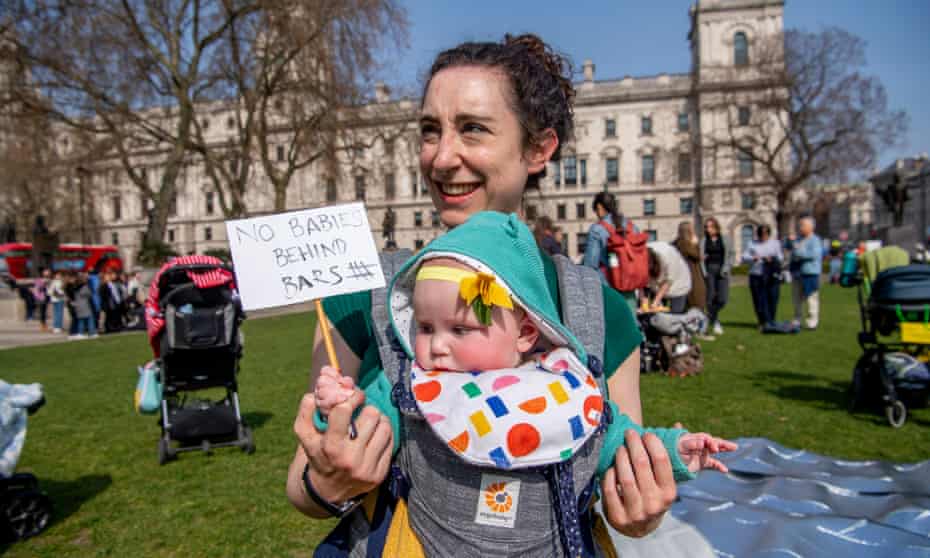 Kate Lewis and baby Cora protest about imprisonment of pregnant women in Parliament Square.