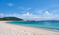 curving white beach and blue sky