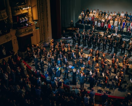 View from high in the theatre of the performers on stage and audience members in the front seats