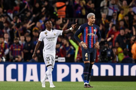 Madrid's Vinicius Junior consoles Barcelona's Araujo after he scored an own goal.