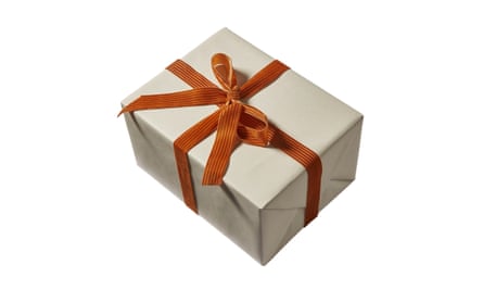Cream wrapping paper with a velvet orange bow