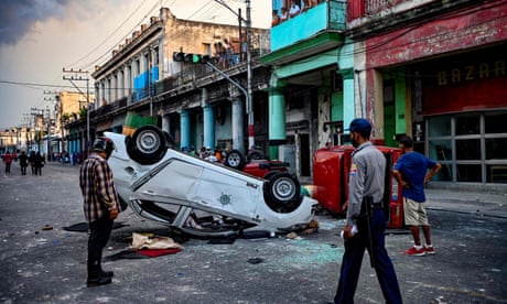 Police cars are overturned in the street in Havana, Cuba, on Sunday during protests against President Miguel Diaz-Canel.