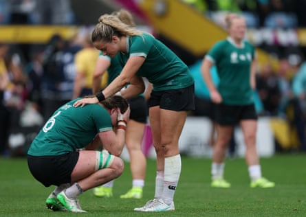 Fiona Tuite crouches with her head in her hands as she is consoled by a teammate after the match
