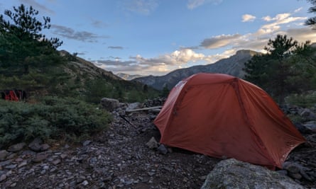 The art of pitching a tent on stony ground – rocks go through the tent peg loops to weight it down.