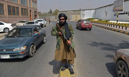 A Taliban fighter patrols a street near Zanbaq Square in Kabul on Thursday.