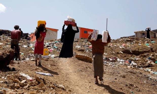 Displaced Yemenis carry food rations provided by a charitable organisation at a camp in Sana’a, Yemen.