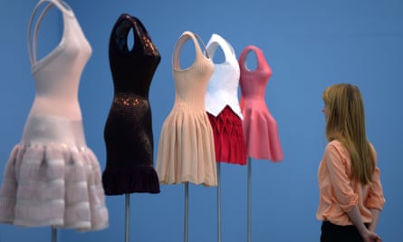 A visitor looks at clothes designed by Azzedine Alaïa at a museum in Germany.
