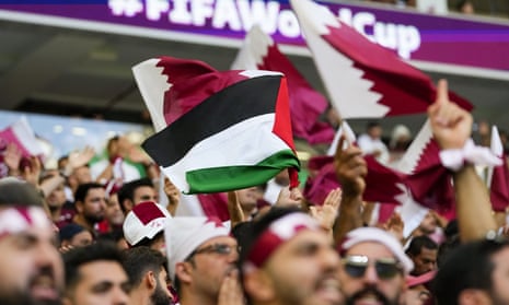 A fan waving a Palestinian flag prior to the World Cup match between Qatar and Senegal.